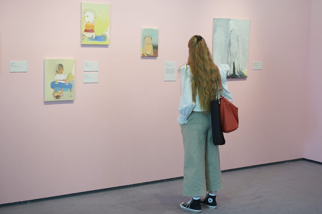 A visitor takes a closer look at Ikemura's Moo, 1993, and other paintings. Photo: Andi Sapey A visitor looking at exhibits by artist Leiko Ikemura at the Sainsbury Centre