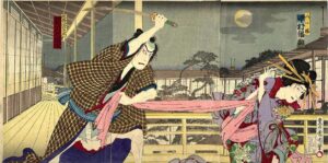 A historic Japanese woodcut print in colour showing two figures, a female on the right and a male on the left, the male figure is pulling af the fabric of the female's clothing as she tries to turn away. He is also holding a large knife up in the air.