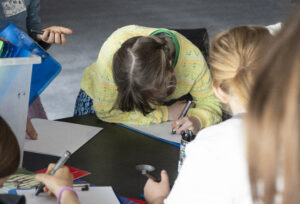 Young girl writes on piece of paper