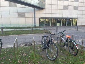 Bicycle racks outside an art museum and two bicycles